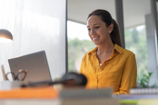 istock Smiling woman working from home 1319393101