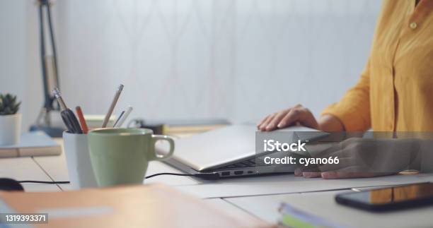 Woman Sitting At Desk And Using Her Laptop Stock Photo - Download Image Now - Laptop, Closing, Finishing