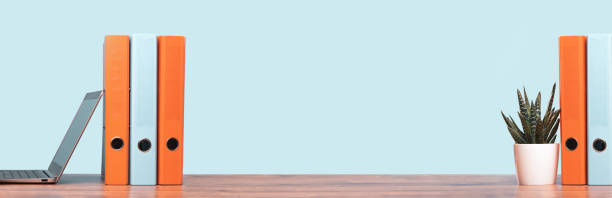 istock Colorful document binders or lever arch file on a shelf or desk banner 1319395641