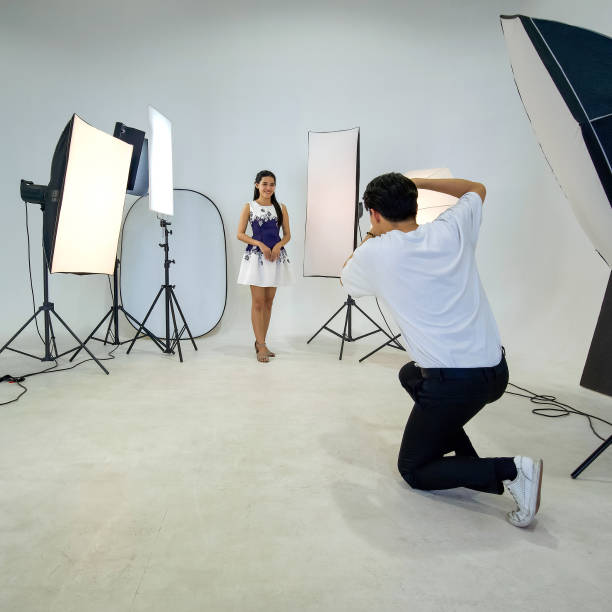 istock An Asian photographer is photographing a model posing in the studio. 1319396941