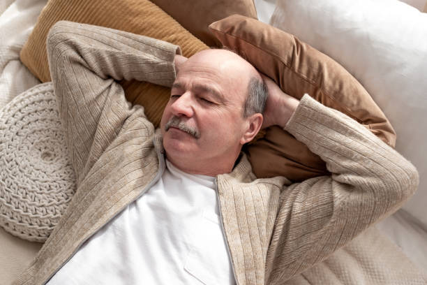 istock Senior hispanic man resting at home sleeping on bed. 1319396996