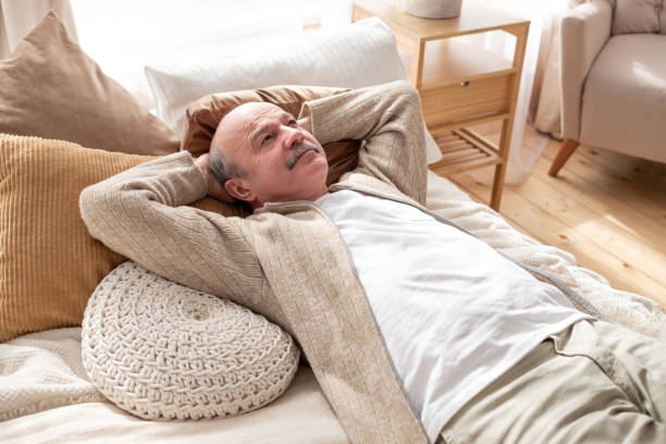 istock Senior hispanic man resting at home sleeping on bed. 1319397034