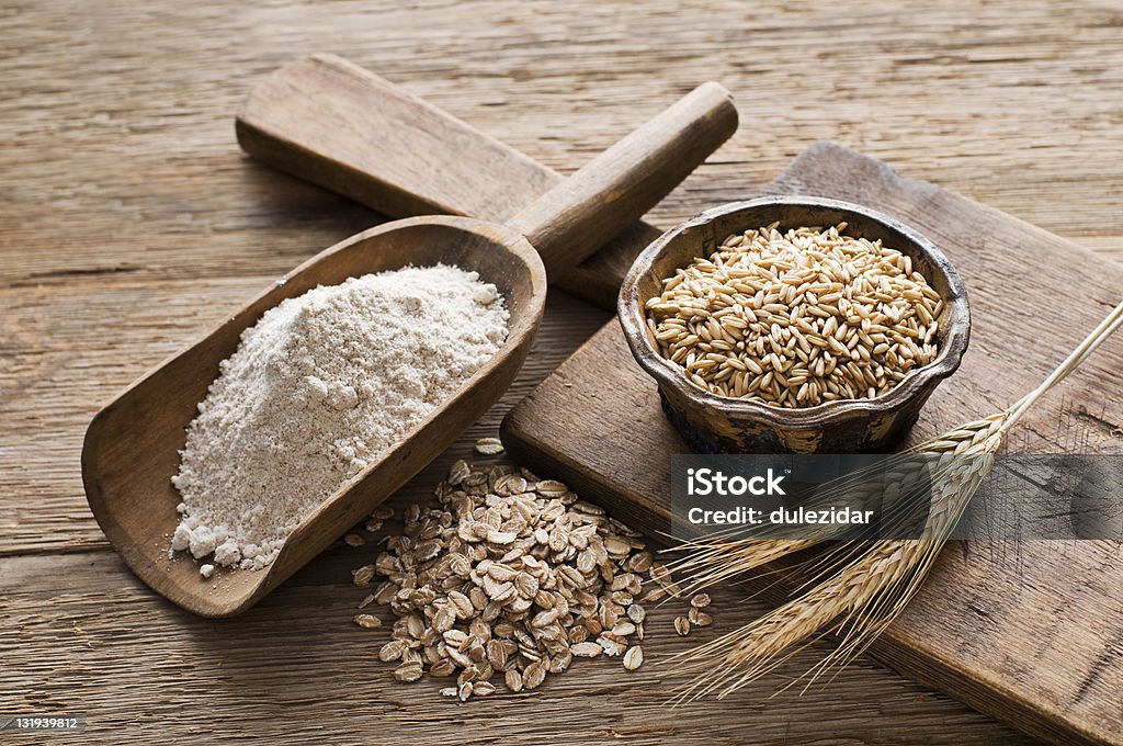 Whole grain Whole grain and flour on wooden background close up Ingredient Stock Photo