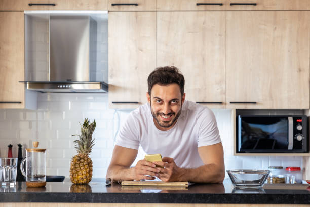 istock Young handsome man ready to cook in the kitchen 1319401702
