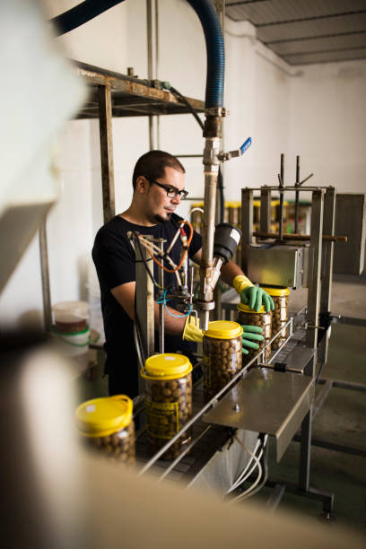 istock Man working at olives factory 1319404302