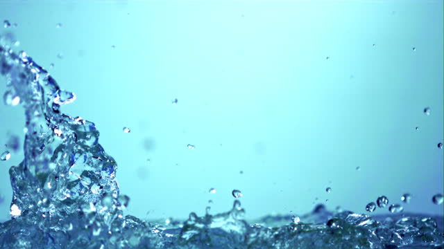 Super slow motion sprays clean water on a blue background. Filmed on a high-speed camera at 1000 fps.