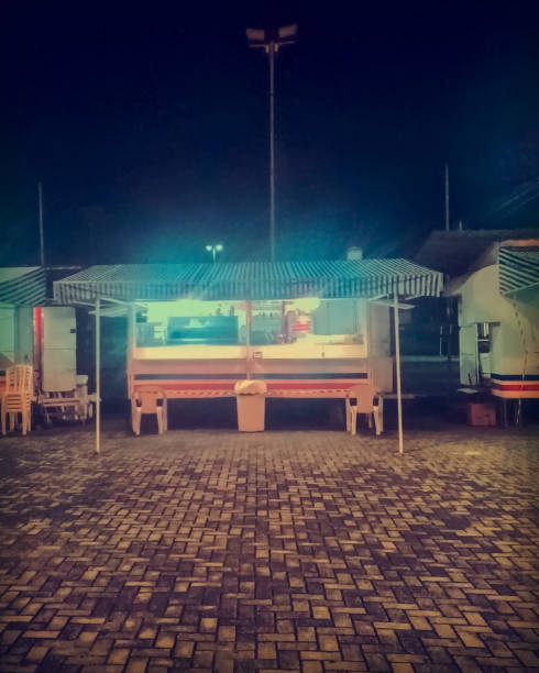 A square with food stalls open at night.