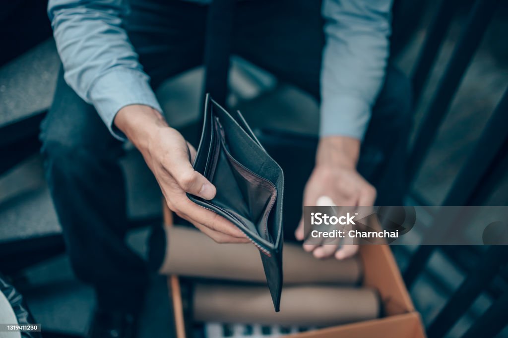 Office worker lost his job and open a wallet without money. Man empty wallet, man broke concept. Empty Wallet Stock Photo