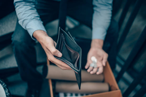 Office worker lost his job and open a wallet without money. Man empty wallet, man broke concept. stock photo