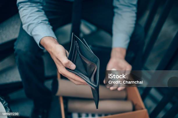Office Worker Lost His Job And Open A Wallet Without Money Man Empty Wallet Man Broke Concept Stock Photo - Download Image Now