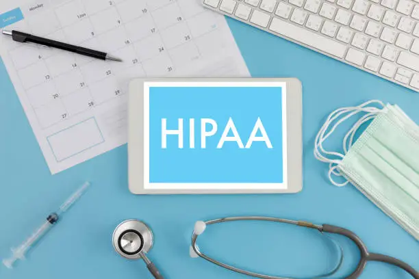 Photo of HIPAA Professional doctor use computer and medical equipment all around, HIPAA privacy rule HIPAA Compliance