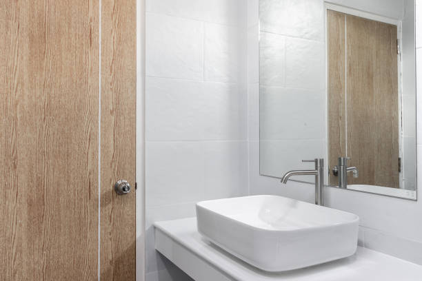 istock Close-up small basin and mirror in small bathroom, On white ceramic wall. 1319414892