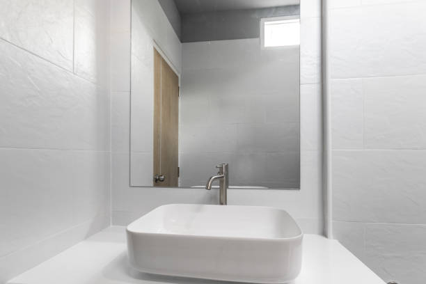 istock Close-up small basin and mirror in small bathroom, On white ceramic wall. 1319414893