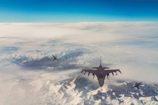 istock Jet fighters flying over the clouds. 1319415433