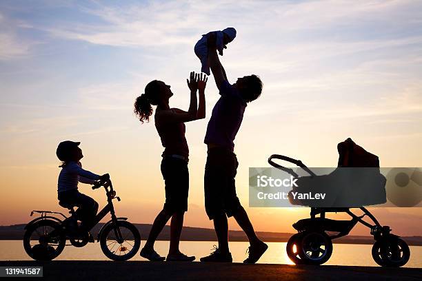 Silhouette Of Happy Family Playing At Sea Coast Stock Photo - Download Image Now - Newborn, In Silhouette, Child