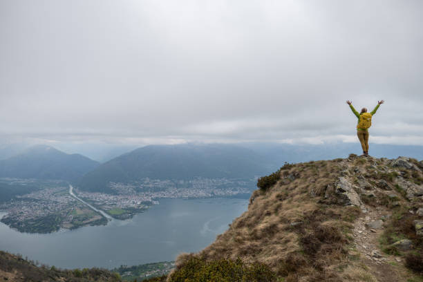 istock Hiker stands arms out on mountain top 1319416906