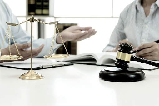 Focus on gavel and scales on the table background Lawyer or judge are discussion  consultation  and advice about law in law firm sepia vintage tone.