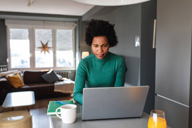 istock Woman at home, using laptop 1319419634