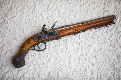 Old Pistol Hanging on Wall as Decoration.
