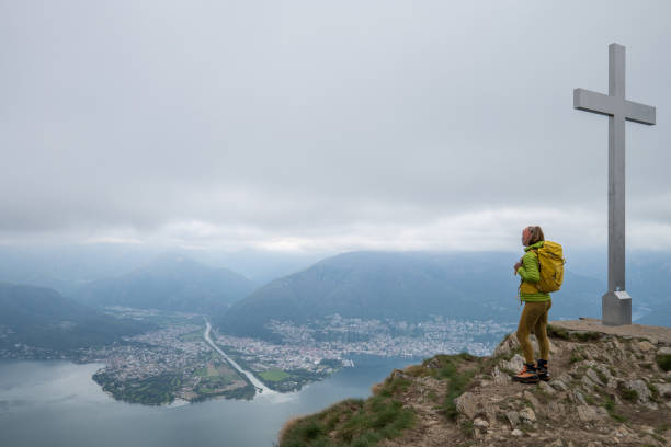 istock Female hiker contemplates view from mountain top 1319419826