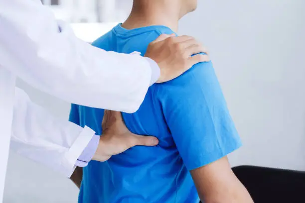 Male doctor therapist working examining treating injured back.Back pain patient, treatment, medical doctor,massage for back pain relief office syndrome."