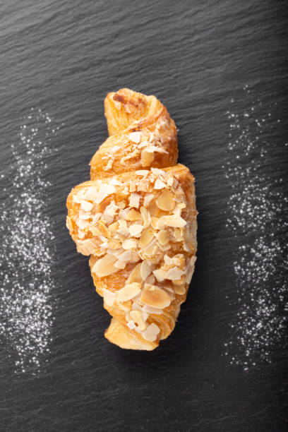 istock Fresh croissant on black board. Top view. 1319422337