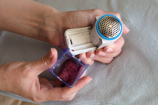 istock A woman disassembles, cleans the device for removing pellets. 1319425425