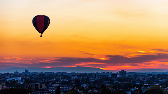 Melbourne, Victoria, Australia, April 2nd 2021: Hot air balloons float above Melbourne suburbs, from Brunswick looking towards the east.