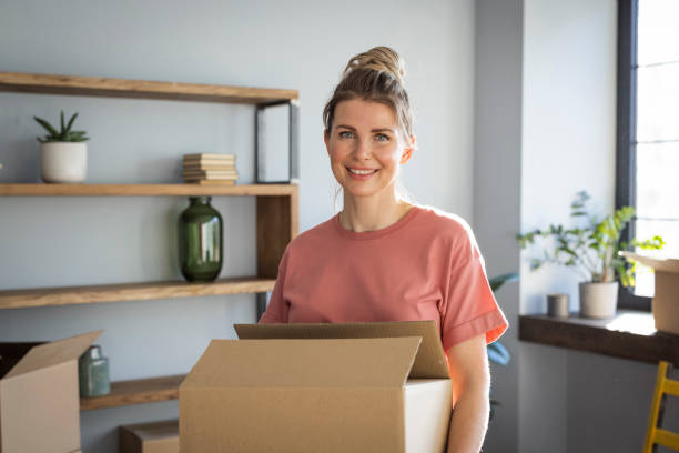 istock Woman moving in new home 1319428493