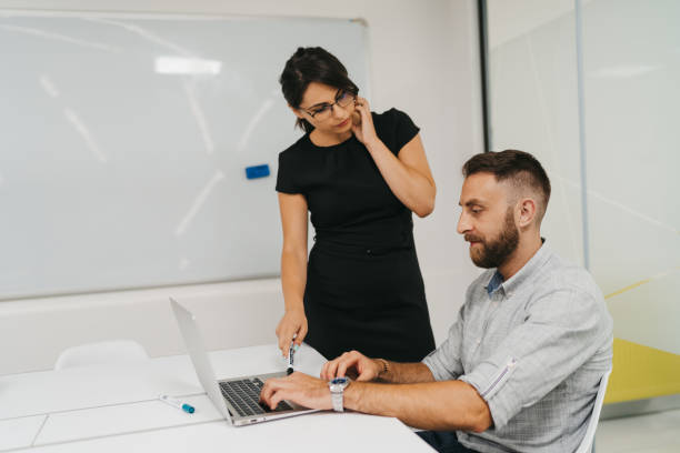 istock Young business people discussing over laptop in office 1319428866