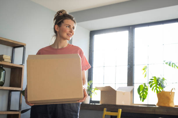istock Woman moving in new home 1319429105