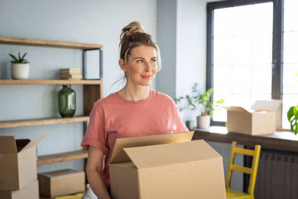 istock Woman moving in new home 1319429243