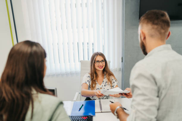 istock Colleagues consulting with manager in modern office 1319429710