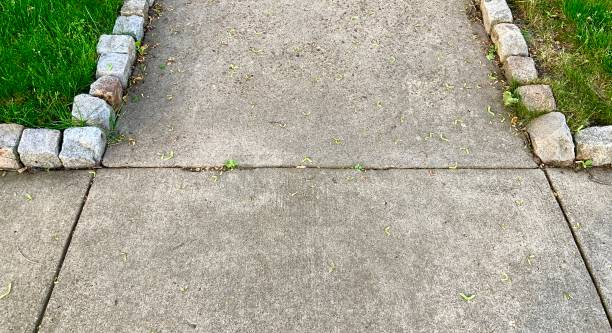 istock Sidewalk and Front Walk Lined with Block Shaped Stones 1319435988
