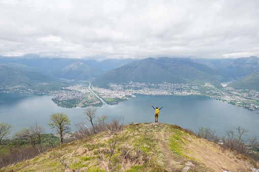Description: Athletic woman enjoys amazing view from Churfürsten hike trail on lake Walensee. Schnürliweg, Walensee, St. Gallen, Switzerland, Europe.