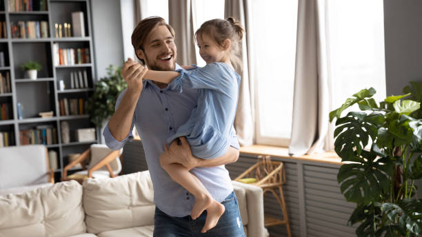 istock Happy dad dance with cute little daughter 1319451857
