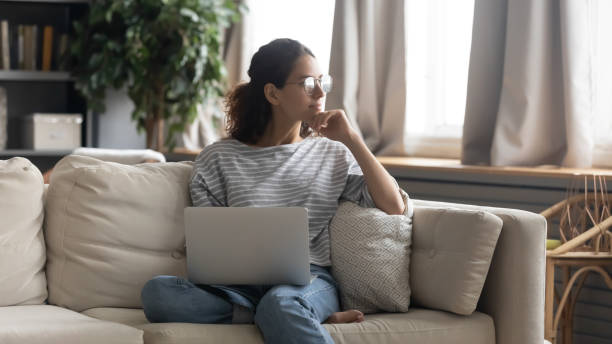 istock Pensive woman work on laptop thinking pondering 1319451867