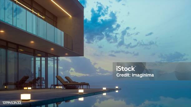 Modern Luxury House With Private Infinity Pool In Dusk Stock Photo - Download Image Now