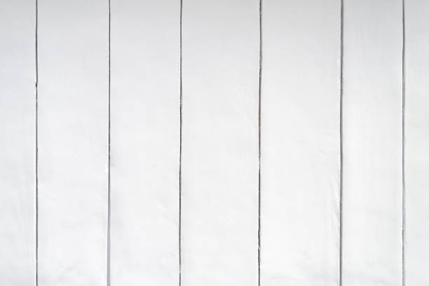 istock Vertical wooden planks close up. The wall is painted light gray. 1319455421