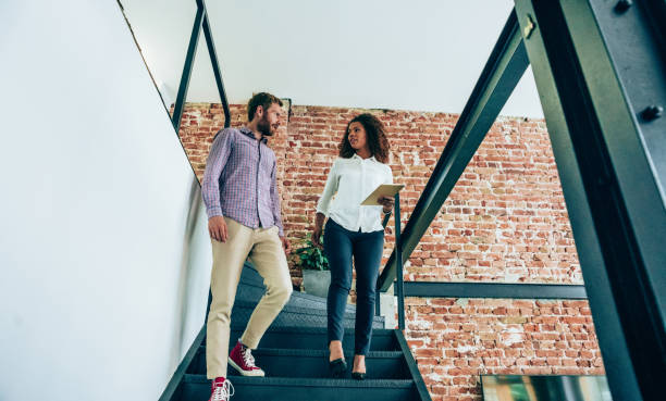istock Business colleagues talking on stairs. 1319457044
