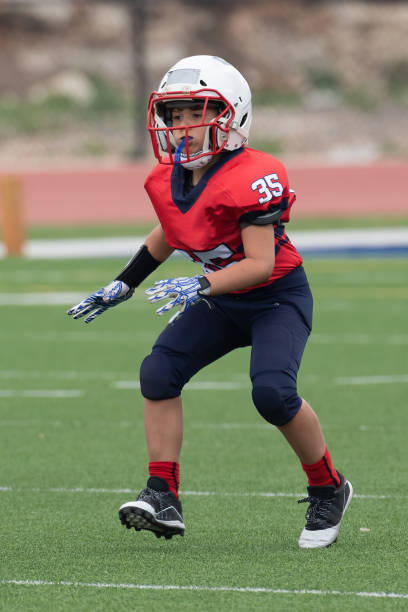 istock Athletic Young Boy Playing in a Football Game 1319459941