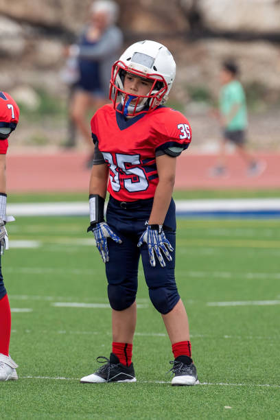 istock Athletic Young Boy Playing in a Football Game 1319459942