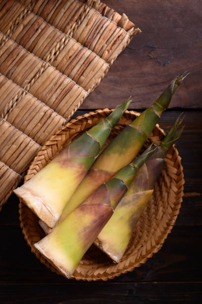 istock Fresh bamboo shoot in a basket on wooden background 1319459950