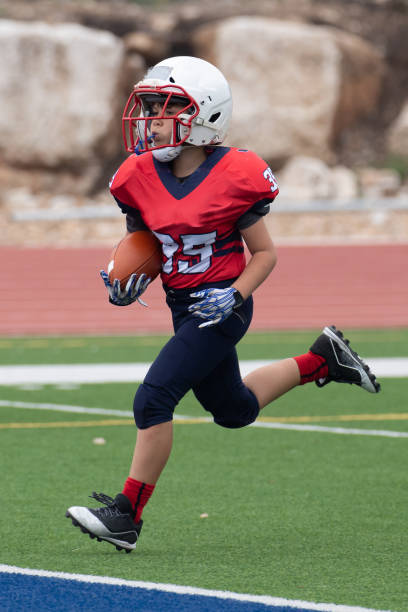 istock Athletic Young Boy Playing in a Football Game 1319459968