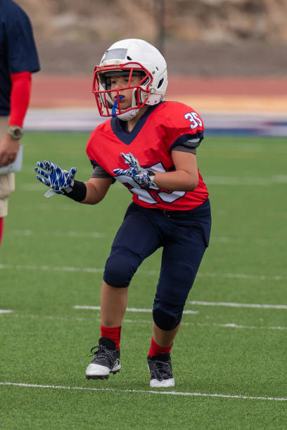istock Athletic Young Boy Playing in a Football Game 1319459998