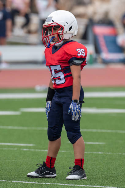 istock Athletic Young Boy Playing in a Football Game 1319460004