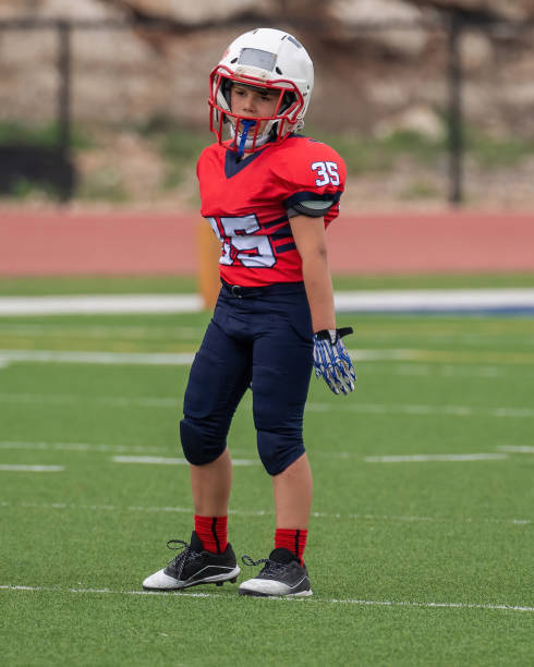 istock Athletic Young Boy Playing in a Football Game 1319460012