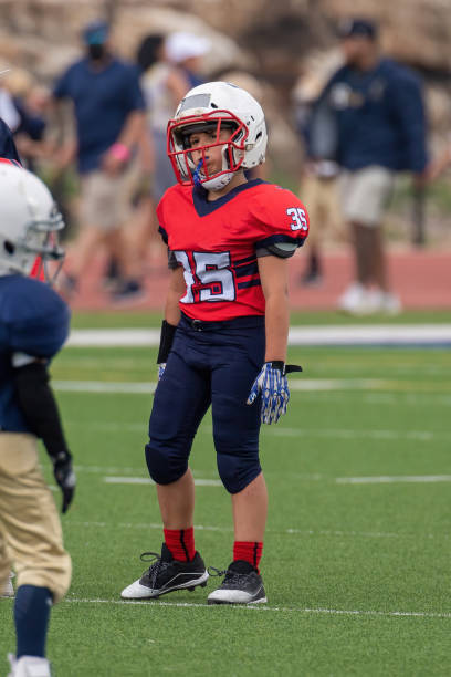 istock Athletic Young Boy Playing in a Football Game 1319460019