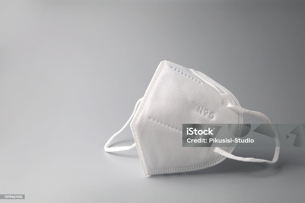 Face mask on a grey background Close up N95 protective face mask to prevent virus Covid-19 N95 Face Mask Stock Photo