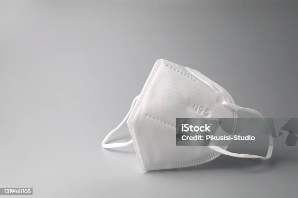 Face Mask On A Grey Background Stock Photo - Download Image Now - N95 Face Mask, Protective Face Mask, COVID-19